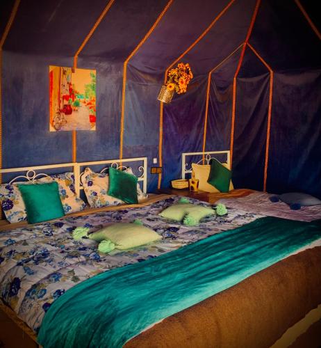 a bedroom with a bed in a tent at Azadic luxury tents in Merzouga