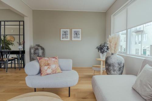 a living room with a couch and a chair at Luxury Townhouse with Panoramic Sea View in Tórshavn