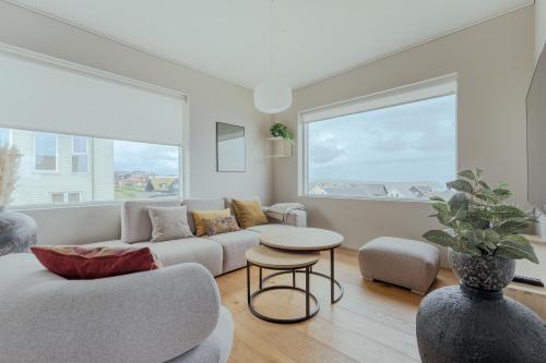 a living room with a couch and a table at Luxury Townhouse with Panoramic Sea View in Tórshavn