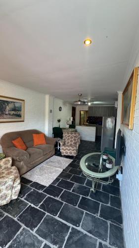 a living room with a couch and a table at Ahava Accommodation in Scottburgh