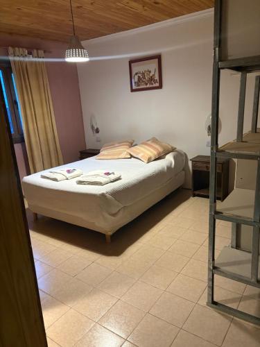 a bedroom with a bed and a ladder at Hostería Altas Cumbres in El Chalten