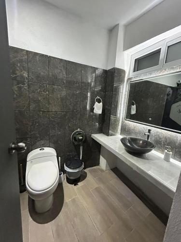 a bathroom with a toilet and a sink at Apartamento Stay and Chill in Panajachel