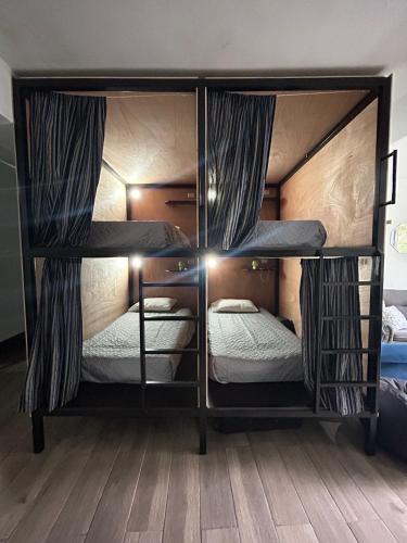 two bunk beds in a room with a wooden floor at Apartamento Stay and Chill in Panajachel