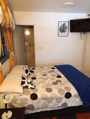 a bedroom with a bed with cow pillows on it at Nora's Casa de familia Laureles in Medellín