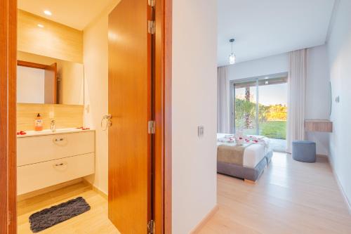 a bathroom with a sink and a bed in a room at Prestigia Family Luxury Apartments in Marrakesh