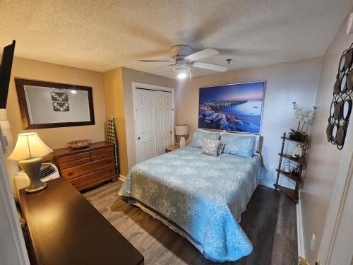 a bedroom with a bed and a ceiling fan at Beachfront Condo with Amazing Ocean Views 4th Fl in Old Orchard Beach