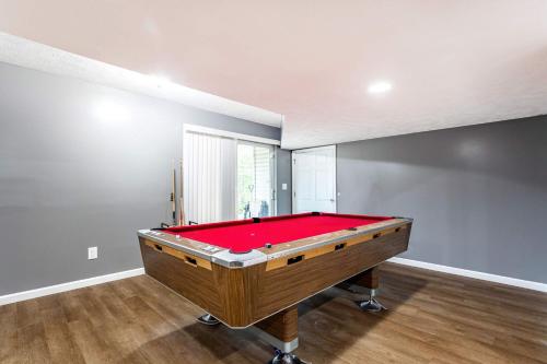 a pool table in a room with a red cover at Lakeside Haven 5 BDR Fire Pit Pet Friendly in Tobyhanna