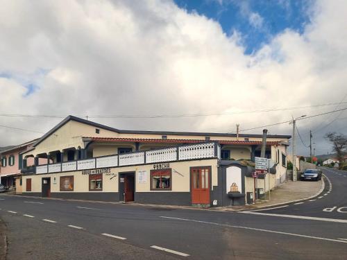 a building on the side of a street at Abrigo dos Prazeres Guesthouse by Mth in Prazeres