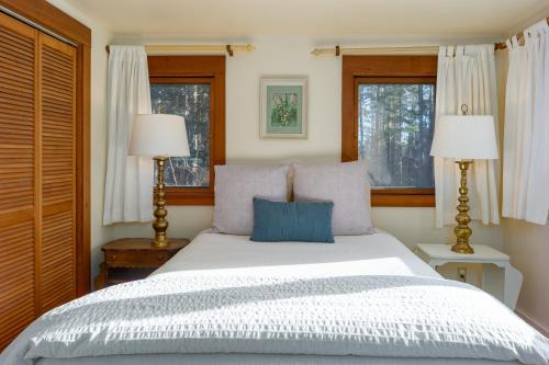 a bedroom with a large white bed with two lamps at Private Pond, Dog-Friendly, Peaceful, Golfing in Eastsound