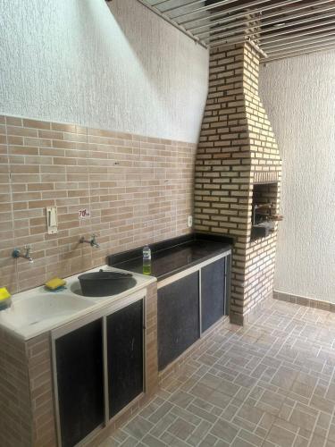 a kitchen with a sink and a brick wall at maray house complete elegance very well located in Formosa