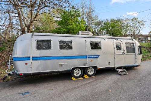 a white trailer parked on the side of a road at Airstream in Art's District in Asheville