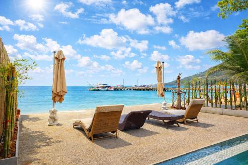 a view of the beach with chairs and umbrellas at Beachfront 4BR Villa with Private Pool - Ocean Access in Chaloklum