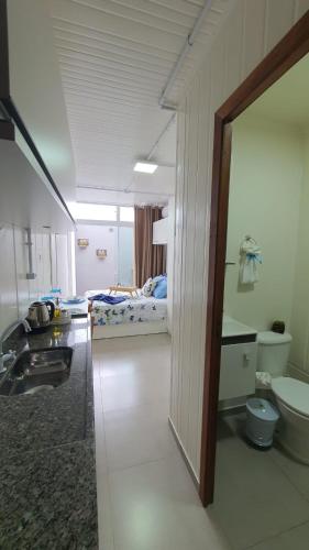 a hospital room with two beds and a bathroom at Blessed Homes in Braço do Norte
