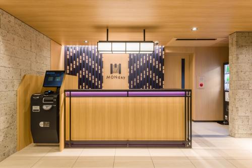 a lobby with a cash counter in a building at MONday Apart Ueno Shinokachimachi in Tokyo
