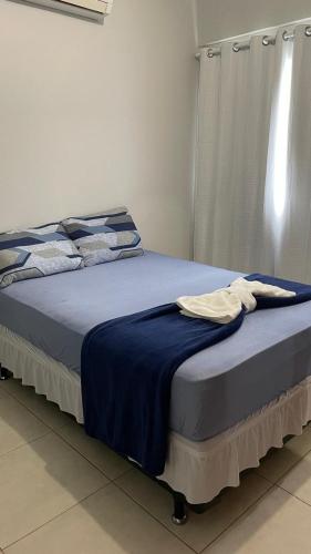 a bedroom with a bed with a blue blanket at Downtown apartment in Sinop