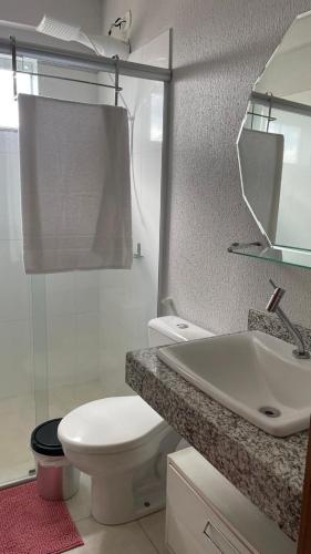 a bathroom with a toilet and a sink and a mirror at Downtown apartment in Sinop