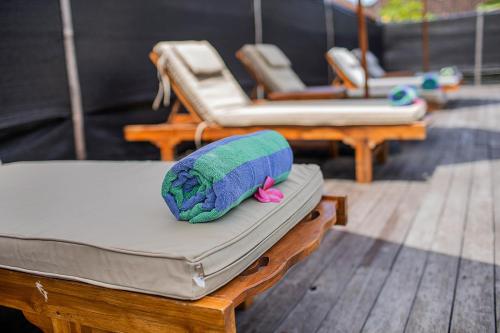 a stuffed animal is sitting on top of a mattress at Samanta Huts in Nusa Lembongan