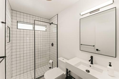 a bathroom with a toilet and a sink and a mirror at The Sawtooth House - Pioneertown Escape with Pool, Spa, Views & Fire Pit in Pioneertown