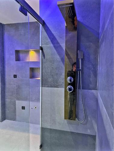a man taking a picture of a shower in a bathroom at Massira 2 in Taza