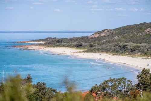 a beach with a bunch of people in the water at Sea Spell I Private Properties in Dunsborough