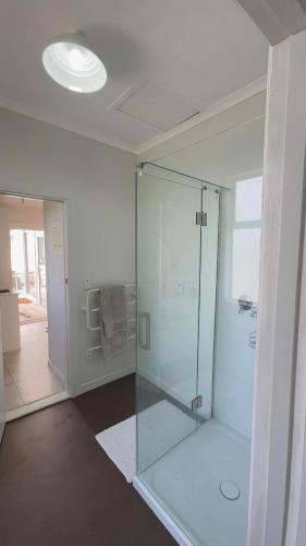 a bathroom with a glass shower in a room at Gosling Grove Hideaway in Turangi