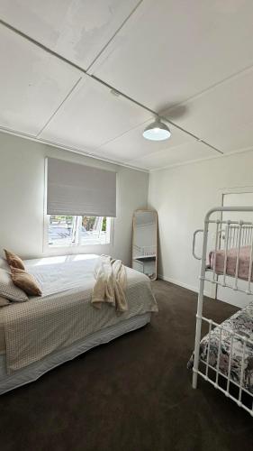 a bedroom with two bunk beds and a ceiling at Gosling Grove Hideaway in Turangi