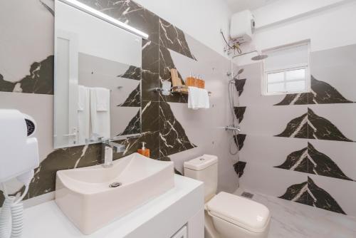 a bathroom with a sink and a toilet at Villa Rosaria - Framed by Nature, Finished with Luxury in Beragala