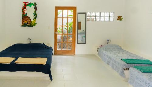 a bedroom with two beds and a door with a window at casa Lucerna in Prado