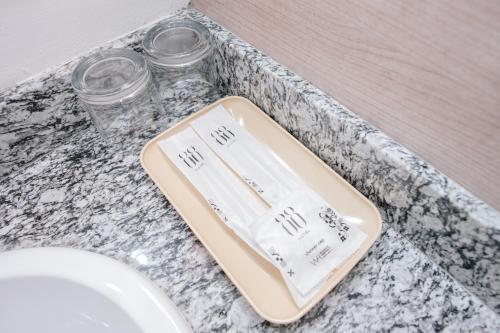 a bathroom counter with a tray and a sink at Hotel 88 Batulicin by WH in Batulicin