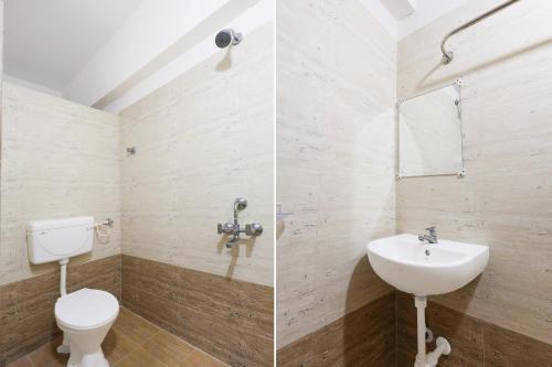 a bathroom with a toilet and a sink at Hotel CJ Grand Vijayawada in Vijayawāda