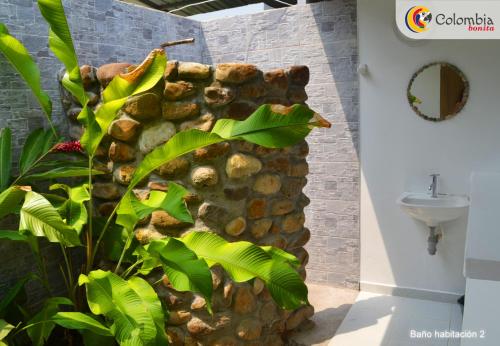 a bathroom with a stone wall next to a sink at casa Lucerna in Prado
