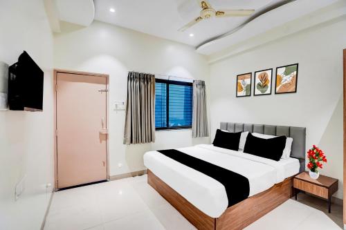 a bedroom with a large bed and a window at Collection O Shendra MIDC Aurangabad Formerly Sai Palace in Aurangabad
