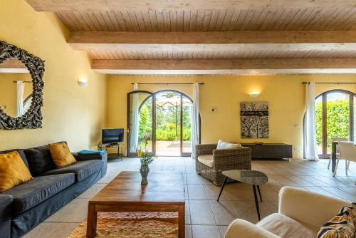 a living room with a couch and a table at Historic Farmhouse Between Two Tuscan Valleys in Trequanda