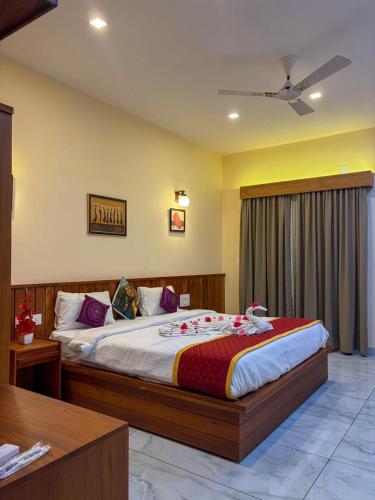 a bedroom with a large bed in a room at Maple grove villa resort in Panamaram