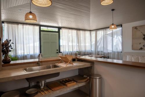a kitchen with a sink and a mirror at KAIA VILLAGE, Santa Teresa, Costa Rica in Santa Teresa Beach