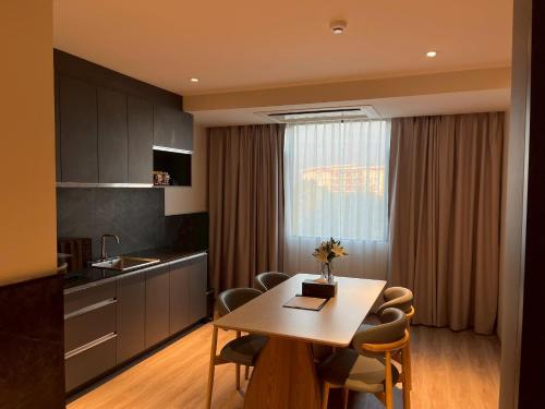 a kitchen with a table and chairs in a room at The Clover in Chiang Mai