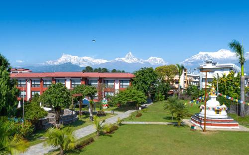 a view of a resort with mountains in the background at Hotel Pokhara Grande in Pokhara