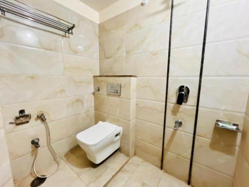 a bathroom with a toilet and a shower at Lijoy Hotel & Restra in Būndi