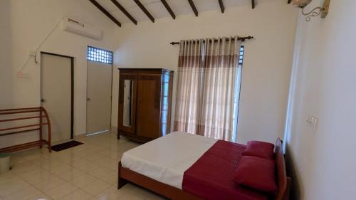 a bedroom with a bed and a staircase in it at Villa 19 Zone 2 Millennium City - Jaela in Ja-Ela
