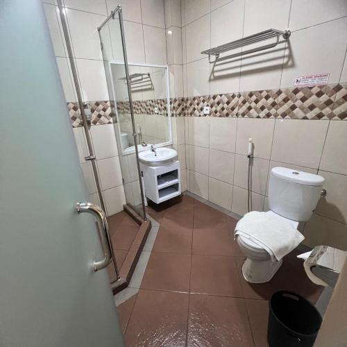 a bathroom with a toilet and a sink at Aamina Syariah Balikpapan in Klandasan-besar