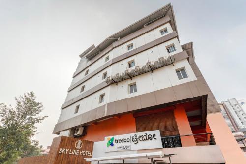 a building with a sign in front of it at Treebo Skyline in Mangalore