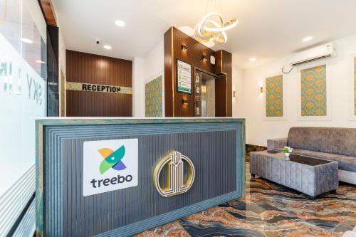a lobby with a treko logo on the wall at Treebo Skyline in Mangalore