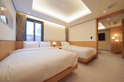 a hotel room with two beds and a window at Incheon No25 Hotel Seogu in Incheon