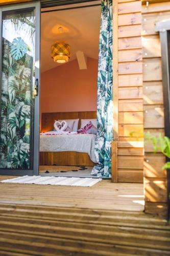 an open door to a bedroom with a bed at Le Palmier de la Paix in Le Tampon