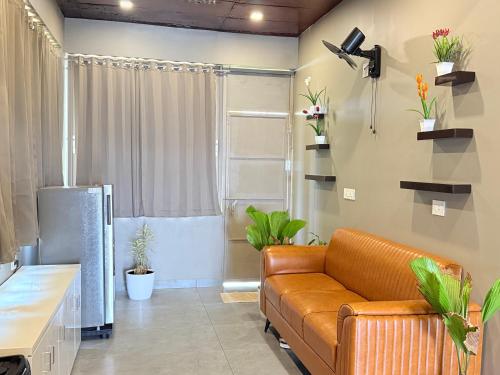a living room with a couch and plants at Valensa lake view in Kalpetta