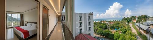 a hotel room with a bed and a view of a city at The Wings Boutique Hotels Krabi Ko Lanta in Ko Lanta