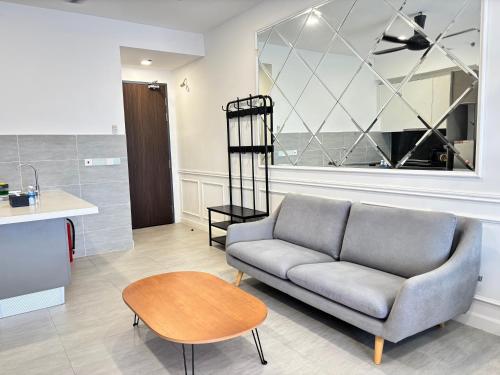 a living room with a couch and a table at Bell Suites by Salaam Suites in Sepang