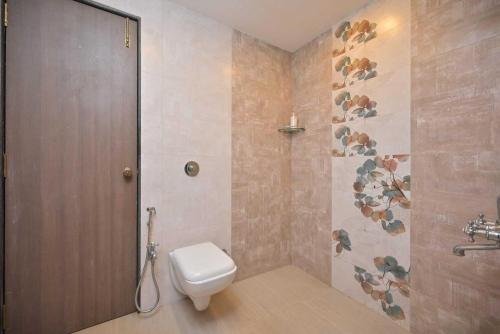 a bathroom with a toilet and a shower at Lifeline Villas - Horizon Backwater Luxe Infinity Pool Villa in Mahabaleshwar