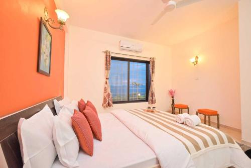 a bedroom with a large bed with a window at Lifeline Villas - Horizon Backwater Luxe Infinity Pool Villa in Mahabaleshwar