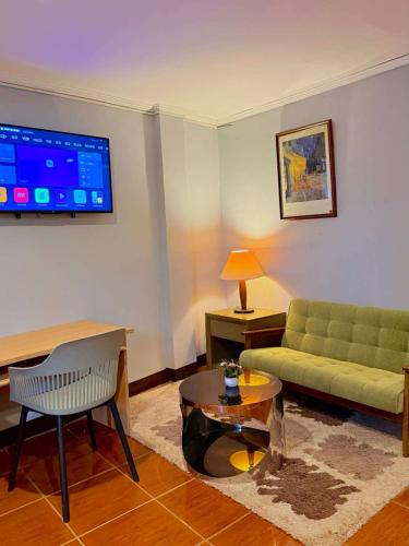 a living room with a couch and a table at Chad's Lodge in Coron
